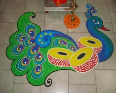 a peacock design on the floor with candles