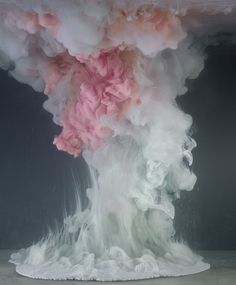 an image of a pink and white cloud on top of a black background