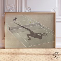 the shadow of a tennis player is shown in front of a framed photograph on a wall