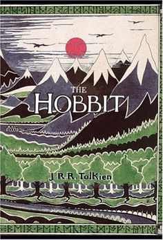 the hobbit book cover with mountains in the background and red lettering on it