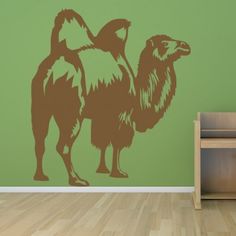 a wall decal with an image of a camel in brown on a green background