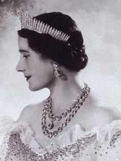 an old black and white photo of a woman wearing a tiara