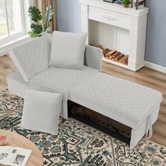 a white couch sitting on top of a rug in a living room