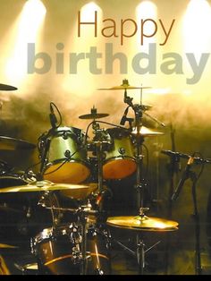 a birthday card with drums and lights on the stage in front of a drummer's drum set