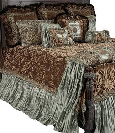 a bed with brown and tan comforters on it's sides, including a headboard