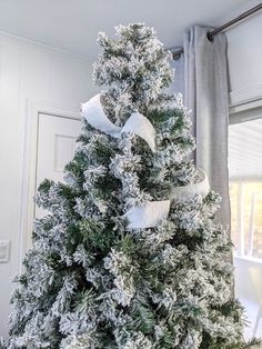 a decorated christmas tree with white bows