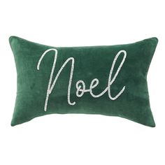 a green and white pillow with the word noel written in cursive writing on it