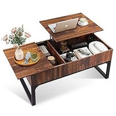 a wooden table with two open drawers on it and a laptop in the middle one