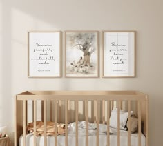 a baby crib with two pictures hanging on the wall