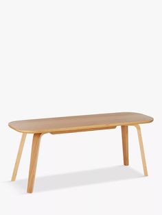 a wooden table sitting on top of a white floor