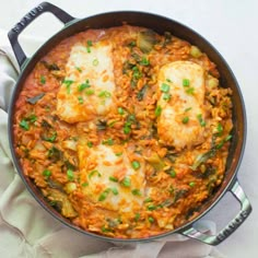 some kind of food in a pan on top of a table with a napkin and spoon