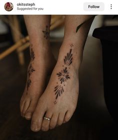 two feet with tattoos on them and one has a flower tattoo on the bottom of it