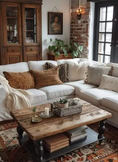 a living room filled with lots of furniture and pillows on top of a wooden table