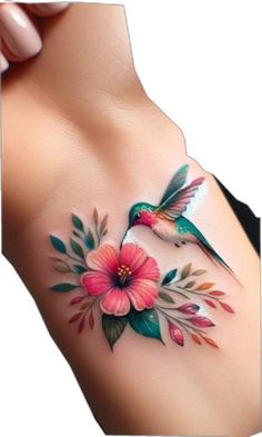 a woman's breast with flowers and hummingbirds on it, painted in watercolor