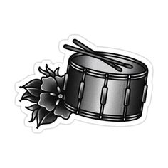 a black and white sticker with a drum and flowers on it's side