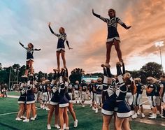 a group of cheerleaders standing on top of each other