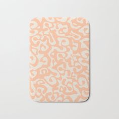 an orange and white animal print bath mat