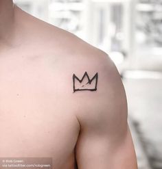 a man's chest with a crown tattoo on the left side of his chest