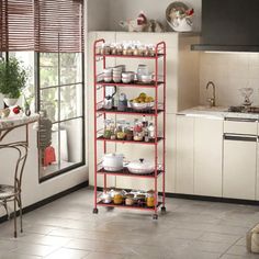 a kitchen with a red rack filled with food