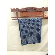 a blue and white cloth hanging on a clothes rack