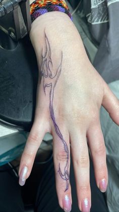 a woman's hand with a tattoo on it