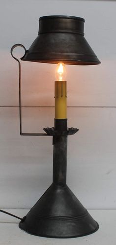 a metal lamp with a lit candle in it