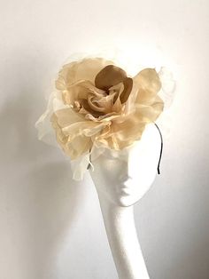 Large gold flower hat This amazing large gold flower hat is made from organza and velvet fabric. The hat sits on the black fabric-covered headband to which I attached small round sinamay base and  a comb so it will sit steadily on your hair. A large gold flower hat will be an amazing accessory to compliment your outfit. It will fit the average head size. You can wear this amazing hat at the wedding, Christening, Horse races, and any other special occasion. Enjoy and please have a look in my shop Gold Curved Brim Hat For Kentucky Derby, Gold Costume Hats For Spring Wedding, Gold Evening Hat For Spring, Gold Costume Hats And Headpieces For Spring Wedding, Gold Hat With Structured Crown For Party, Gold Mini Hat For Spring Evenings, Gold Mini Hat For Evening In Spring, Gold Curved Brim Costume Hat For Summer, Gold Mini Hat For Spring Evening