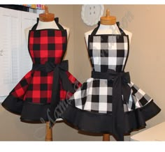 two mannequins dressed in black and red checkered aprons with bow ties