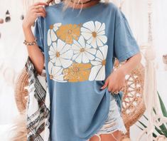 This Boho Wildflowers Comfort Colors Shirt is the perfect blend of relaxed style and nature-inspired beauty. Featuring a distressed floral graphic with vibrant wildflowers, it captures the essence of Matisse-inspired artistry and the charm of a flower market. The soft, vintage-inspired fabric offers all-day comfort, while the cozy, lived-in look makes it an ideal addition to any casual wardrobe. With its bohemian flair and cottagecore vibes, this t-shirt makes a thoughtful gift for anyone who lo Free Spirit Aesthetic, Flower T Shirt, Cottagecore Vibes, Matisse Inspired, Boho Shirt, Floral Graphic, Boho Shirts, Comfort Colors Shirt, Flower Market