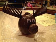 a brown plastic object with large horns on it's head sitting on top of a table