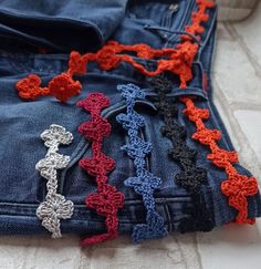 several crocheted crosses are placed in the back pocket of a pair of jeans