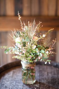 a vase filled with flowers sitting on top of a table