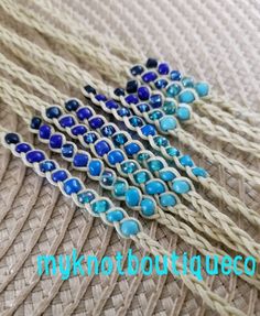 blue and white beads are on the side of a piece of cloth