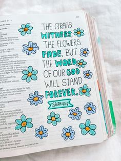 an open bible with flowers on it and the words, the grass, the flowers, the flowers have but the word of god will stand forever