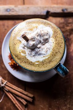 a cappuccino with whipped cream and cinnamon sticks