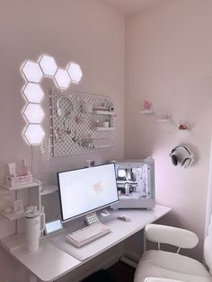 a white desk with a computer on top of it next to a chair and lamp