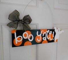 a door hanger that says booy y'all with a black and orange polka dot bow