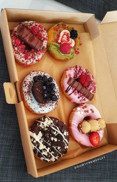 a box filled with lots of different flavored donuts