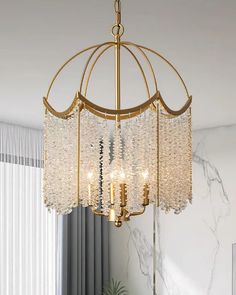 a chandelier hanging from the ceiling in a room with white walls and curtains