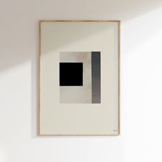 a white wall with a black square on it