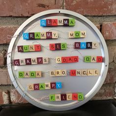 the word grandma spelled with scrabbles in front of a brick wall,