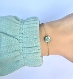 "Abalone Shell Bracelet ~ Silver or gold plated chain, 1\" extension chain to adjust. ~ Dainty natural abalone shell flat coin bead ~ Lobster clasp to close __SIZING__ Small      6\" shortest length Medium  7\" shortest length Large       8\" shortest length P R O D U C T I O N   T I M E S ~ Every single item in our shop is handmade to order with care!  ~ Please note that shipping time does not include production times. ~ Please see our shop policies for full details. C A R E   I N S T R U C T I Adjustable Mother Of Pearl Bracelets As Gifts, Adjustable Mother Of Pearl Bracelets For Gifts, Adjustable Mother Of Pearl Bracelet As Gift, Gold Abalone Shell Round Jewelry, Adjustable Dainty Mother Of Pearl Jewelry, Perle Plate, Abalone Shell Bracelet, Abalone Bracelet, Sea Opal