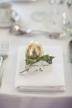 a place setting with silverware and napkins on the table for guests to eat