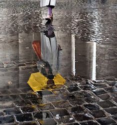 a person walking in the rain with an umbrella