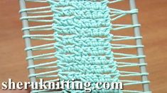 there is a blue crochet stitch on the side of a piece of fabric