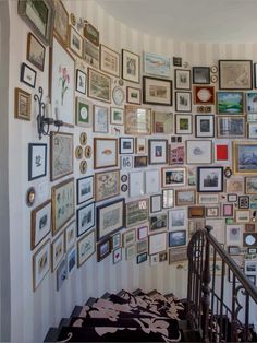 a staircase with many framed pictures on the wall