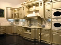 a kitchen with beige cabinets and white appliances