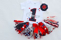 Patriotic 1st birthday outfit personalized . Listing includes applique top, and fabric tutu, hair bow is sold separately .   Please note that some fabrics/ribbons may look a bit different than shown . Set includes: ~Custom made and personalized bodysuit as shown in picture. Bodysuits are available in sizes 3mo. thru 24mo. ~matching fabric tutu skirt is made on ribbon for longer more flexible wear,mixed with tulle and layers of designer fabrics ,8- 9in. long . Each tie of the tutu is hand torn fo First Birthday Girl Outfit, Baby Girl First Birthday Outfit, Girl First Birthday Outfit, Cake Smash Outfit Girl, Monogram Baby Girl, First Birthday Outfit Girl, Patriotic Fabric