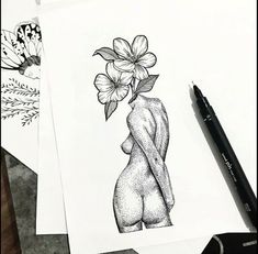 some drawings are laying on top of paper and one has a flower in its head