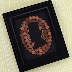 a shadow frame with some coins in it